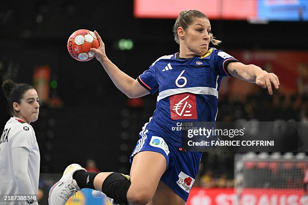 France's wing Chloe Bouquet Valentini throws the ball and scores a goal during the women's EHF 2024 European championship handball game between...