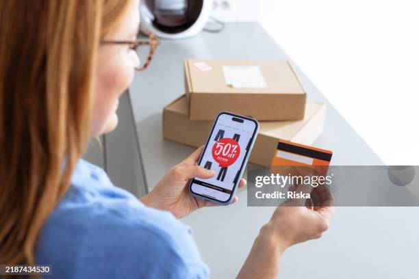 woman shopping online with credit card during a special discount sale - home shopping stock pictures, royalty-free photos & images