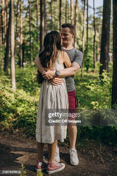 Affectionate Couple Hugging In A Forest High-Res Stock Photo - Getty Images