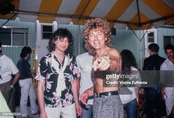 British musicians Jimmy Page and Robert Plant pictured backstage at Live Aid in Philadelphia after performing with a re-formed Led Zeppelin, July...