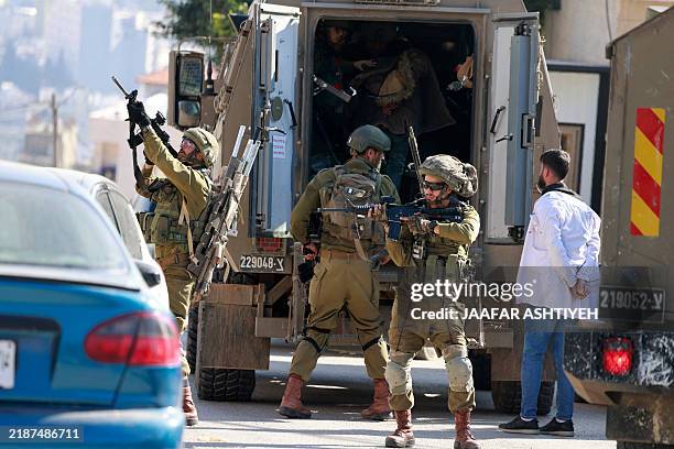 Israeli soldiers detain members of staff from the Tubas Turkish Governmental Hospital in Tubas in the occupied West Bank on December 3, 2024.