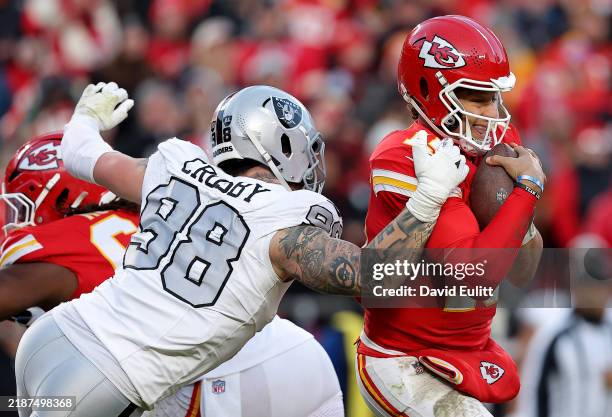 Patrick Mahomes of the Kansas City Chiefs escapes a sack against Maxx Crosby of the Las Vegas Raiders during the third quarter in the game at GEHA...