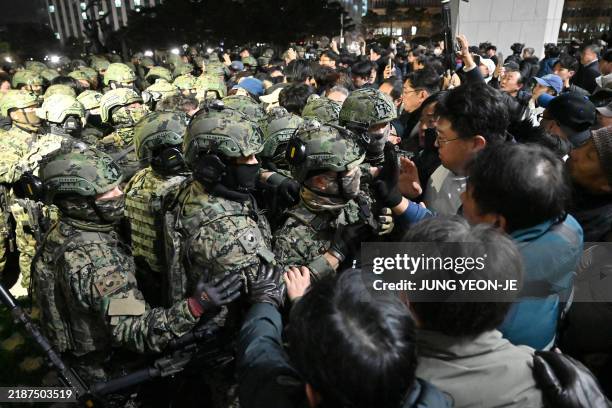 Soldiers try to enter the National Assembly building in Seoul on December 4 2024, after South Korea President Yoon Suk Yeol declared martial law....