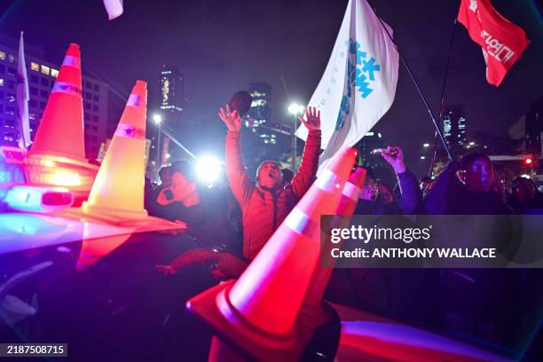 People gather outside the National Assembly in Seoul on December 4 after South Korea President Yoon Suk Yeol declared martial law. South Korea's...