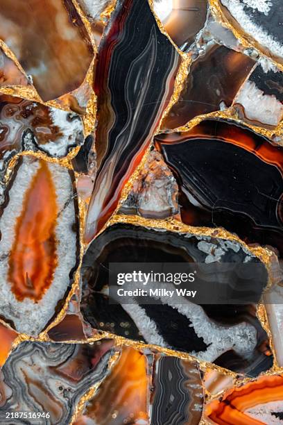 slices of the colorful polished semi-precious stones. semi precious stones background. agate stone texture with rich colors and gold veining for design projects. - stone polishing stock pictures, royalty-free photos & images