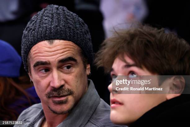 Irish actor Colin Farrell and his son James look on during the Emirates NBA Cup game between the Los Angeles Lakers and the Oklahoma City Thunder at...