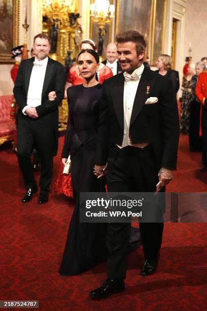 Victoria and David Beckham make their way along the East Gallery to attend the State Banquet at Buckingham Palace during day one of The Amir of the...