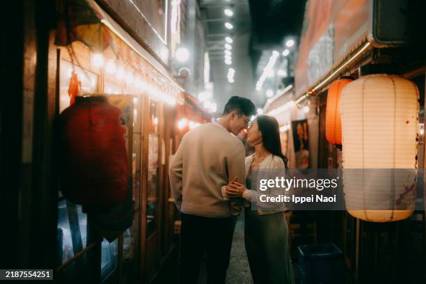 couple having fun in narrow market alleyway at night in tokyo - night market stock pictures, royalty-free photos & images