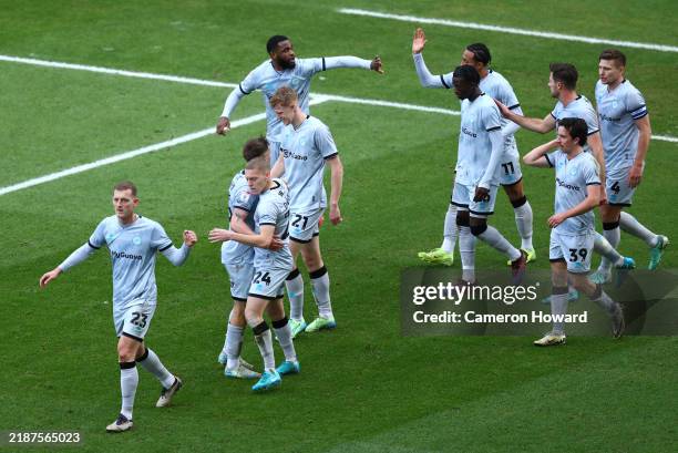 Japhet Tanganga of Millwall celebrates with teammates after scoring his team's first goal during the Sky Bet Championship match between Oxford United...