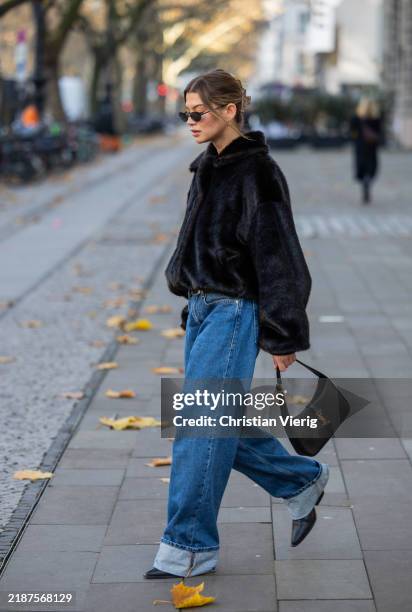 Sophia Geiss wears sunglasses vehla eyewear, black jacket the Frankie shop, cuffed denim jeans Calvin Klein, shoes LeGer by Lena Gercke, bag YSL on...