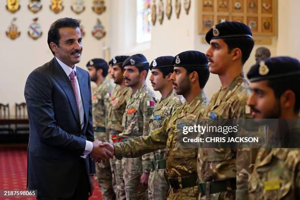 Qatar's Emir Sheikh Tamim bin Hamad al-Thani meets with Qatari cadets during a visit to he Royal Military Academy Sandhurst, southwest of London on...