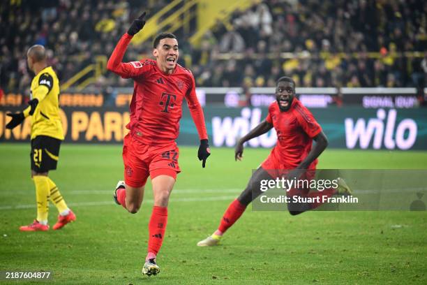 Jamal Musiala of Bayern Munich celebrates scoring his team's first goal during the Bundesliga match between Borussia Dortmund and FC Bayern München...