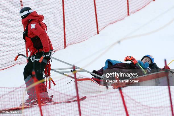 Mikaela Shiffrin of the United States is taken off the course by ski patrol after a crash during the second run of the Women's Giant Slalom during...