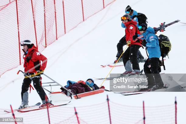 Mikaela Shiffrin of the United States is taken off the course by ski patrol after a crash during the second run of the Women's Giant Slalom during...
