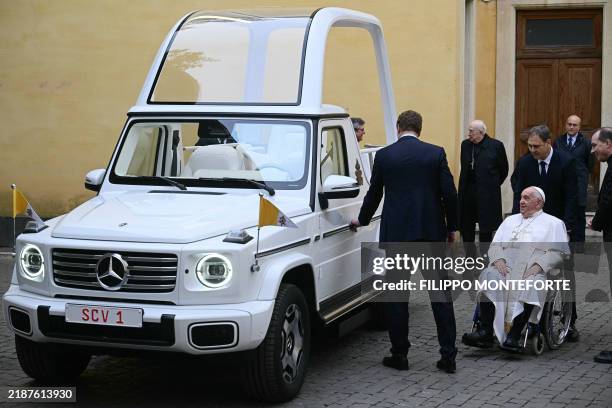 Pope Francis looks on as he's presented a new fully electric popemobile, at the Vatican on December 4, 2024.