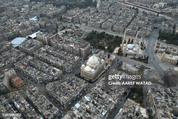 An aerial view shows the St. Georges Church , Holy Cross Church and Al-Tawheed Mosque in Syria's second city Aleppo on December 4, 2024.
