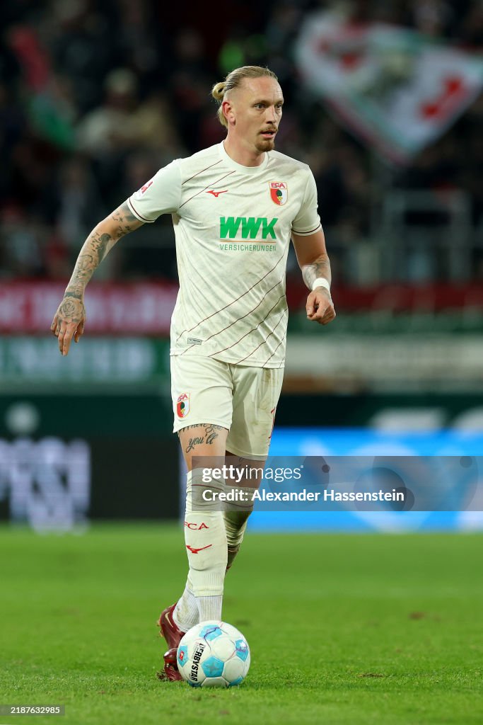 Mwolf Marius Wolf of Augsburg runs with the ball during the Bundesliga ...