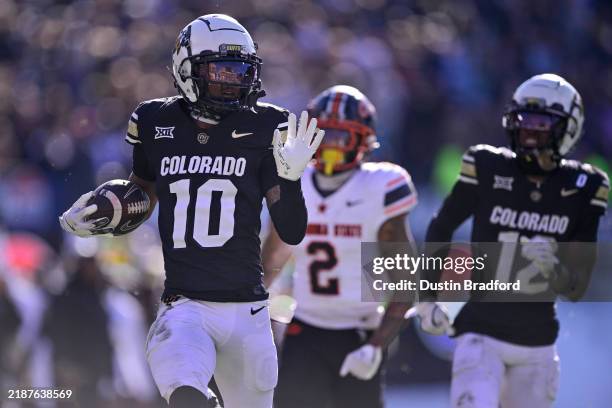LaJohntay Wester of the Colorado Buffaloes runs before scoring his third quarter touchdown against the Oklahoma State Cowboys at Folsom Field on...