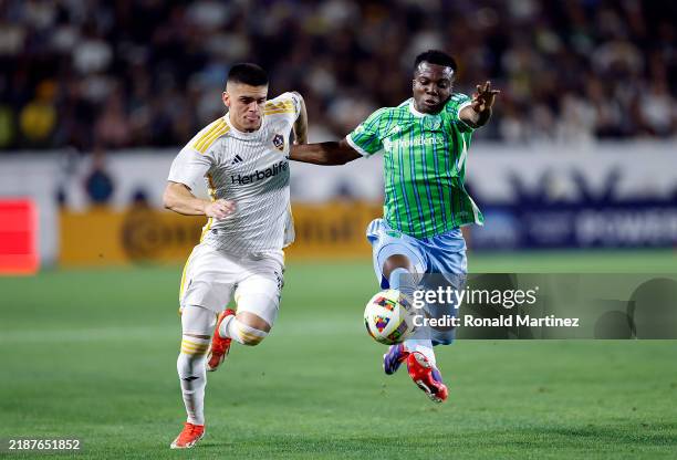 Gabriel Pec of Los Angeles Galaxy and Nouhou Tolo of Seattle Sounders in the first half at Dignity Health Sports Park on November 30, 2024 in Carson,...