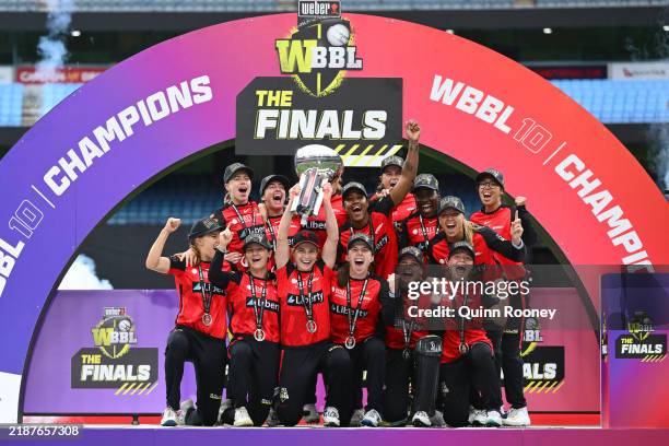 Sophie Molineux of the Renegades lifts the WBBL trophy as the Renegades celebrate victory during the WBBL Final match between Melbourne Renegades and...