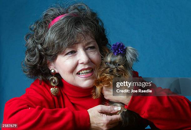 Linda Hopson holds her dog named Tiny Pinocchio June 2, 2003 in St. Petersburg, Florida. Hopson is vying to have her dog named the world's smallest...