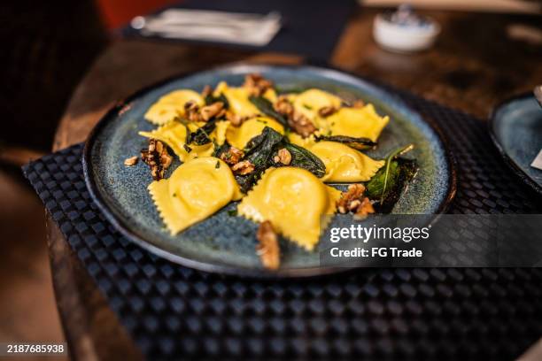 ravioli dish on a dining table - tortellini stock pictures, royalty-free photos & images