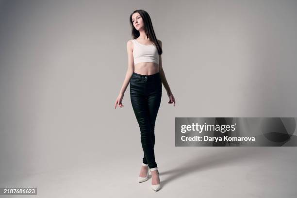 a young woman is standing on a cyclorama. - cyclorama telón de fondo fotografías e imágenes de stock
