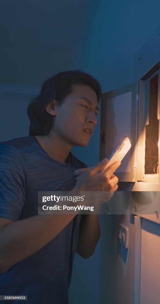 Asian man with power outage