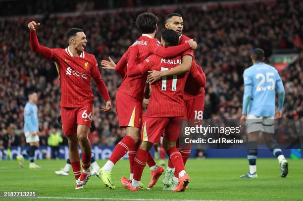 Cody Gakpo of Liverpool celebrates scoring his team's first goal with Dominik Szoboszlai and Mohamed Salah during the Premier League match between...