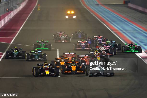 George Russell of Great Britain driving the Mercedes AMG Petronas F1 Team W15 and Max Verstappen of the Netherlands driving the Oracle Red Bull...