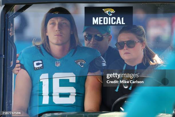 Quarterback Trevor Lawrence of the Jacksonville Jaguars is taken off the field in a medical cart during the second quarter of a game against the...