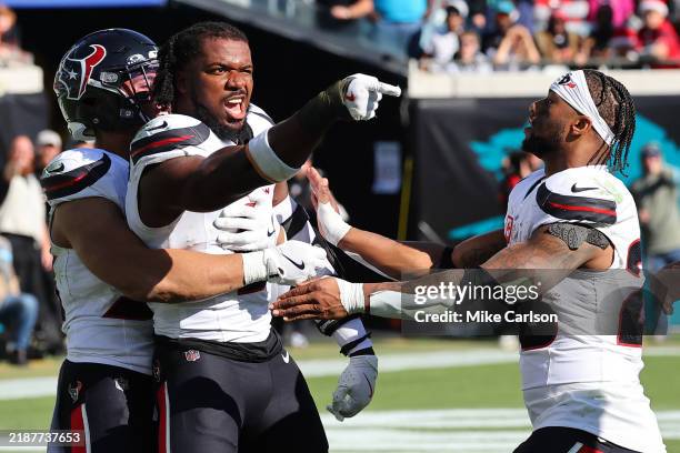 Azeez Al-Shaair of the Houston Texans points to the Jacksonville Jaguars bench after a fight and being ejected during the second quarter of a game at...
