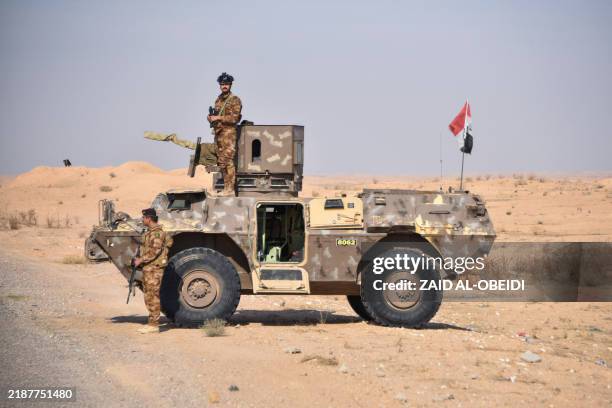 Picture taken during a tour organised by Iraq's Hashed al-Shaabi shows members of a joint Hashed and Iraqi army force standing guard at the...