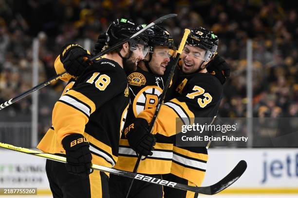 David Pastrnak of the Boston Bruins celebrates with Charlie McAvoy and Pavel Zacha after scoring a goal against the Montreal Canadiens during the...
