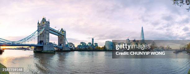 the iconic battlements of tower bridge spanning the river thames towards the embankment in the heart of london. - london bridge stock pictures, royalty-free photos & images