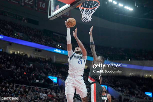 Daniel Gafford of the Dallas Mavericks shoots the ball against Deandre Ayton of the Portland Trail Blazers during the first half at Moda Center on...