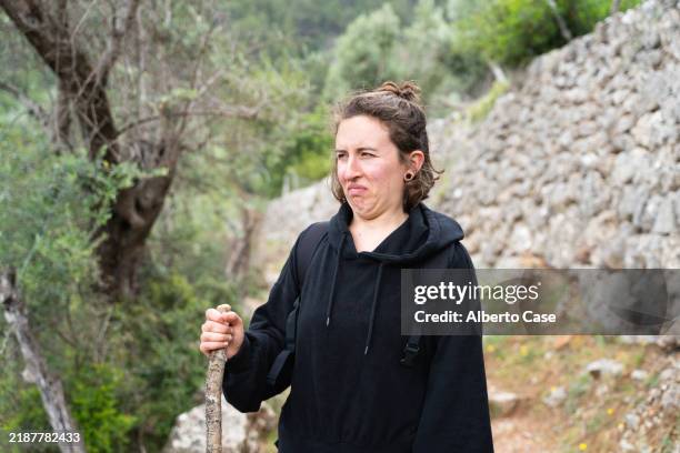 hiker making disgusted face while hiking on trail - disgust stock pictures, royalty-free photos & images