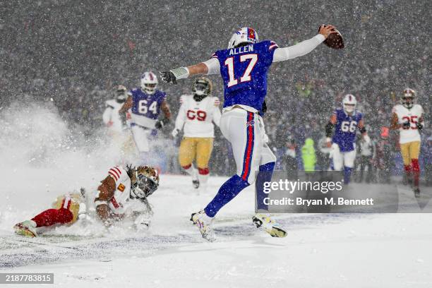 Josh Allen of the Buffalo Bills breaks a tackle by Fred Warner of the San Francisco 49ers as he runs in for a touchdown in the fourth quarter of a...