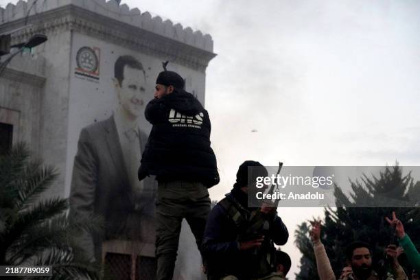 People gather in the city center, celebrating the anti-regime armed groups, opposing the Bashar al-Assad regime taking control of the city center of...