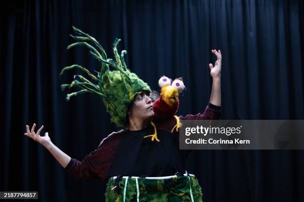 actress in a tree costume rehearsing with a bird puppet on her shoulder for a children's theater play - stock photo - figurino imagens e fotografias de stock