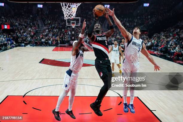 Deandre Ayton of the Portland Trail Blazers shoots the ball against Dwight Powell and Jaden Hardy of the Dallas Mavericks during the first half at...