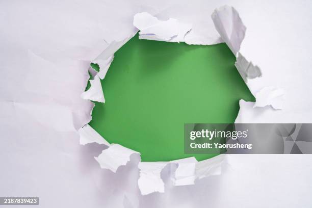 torn paper hole - bullet hole stock pictures, royalty-free photos & images