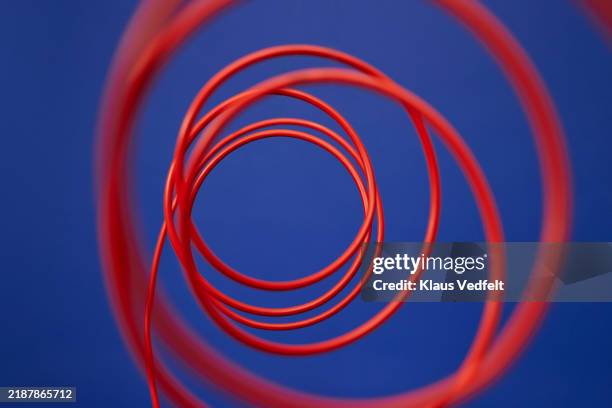 close-up of red circular cable - flexibility stock pictures, royalty-free photos & images
