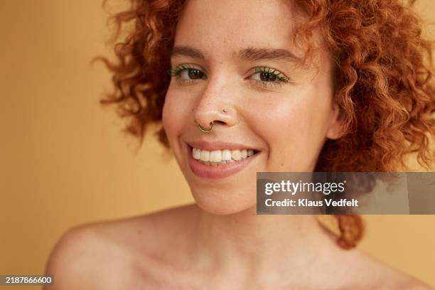 smiling young non-binary person wearing nose ring - semi dress stock pictures, royalty-free photos & images