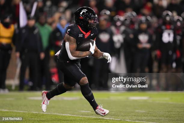 Corey Kiner of the Cincinnati Bearcats runs with the ball in the first quarter against the TCU Horned Frogs at Nippert Stadium on November 30, 2024...