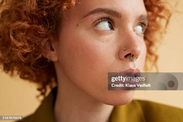 close-up of young redhead non-binary person - pierced stock pictures, royalty-free photos & images