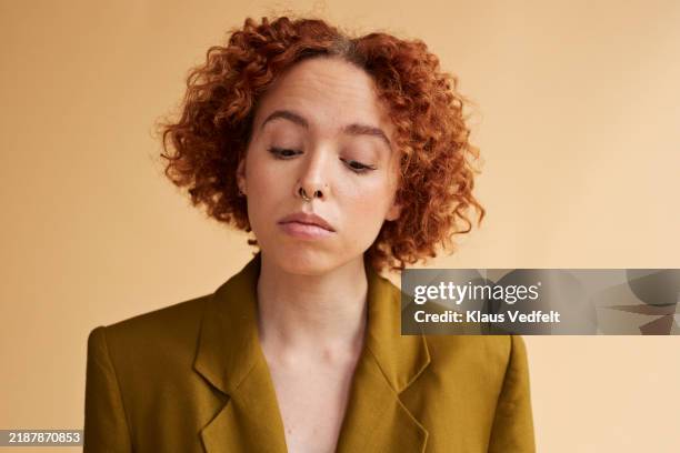 young redhead non-binary person looking down - regarder vers le bas photos et images de collection