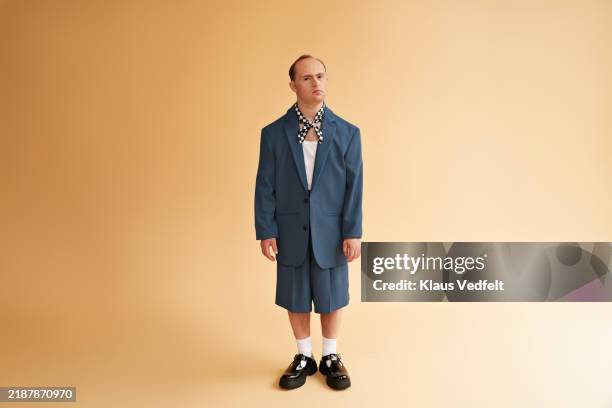 man with down syndrome wearing blue blazer - disability stock pictures, royalty-free photos & images