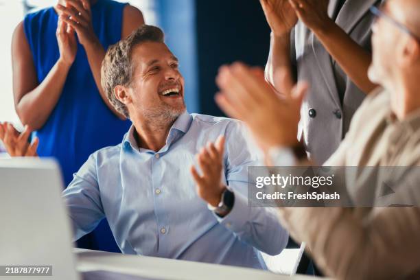 business team celebrating success with enthusiastic applause - satisfaction stock pictures, royalty-free photos & images