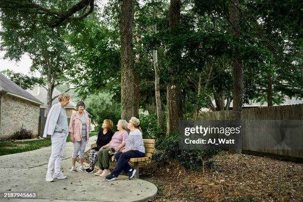 senior women friends chatting after morning walk outdoors - neighbor stock pictures, royalty-free photos & images
